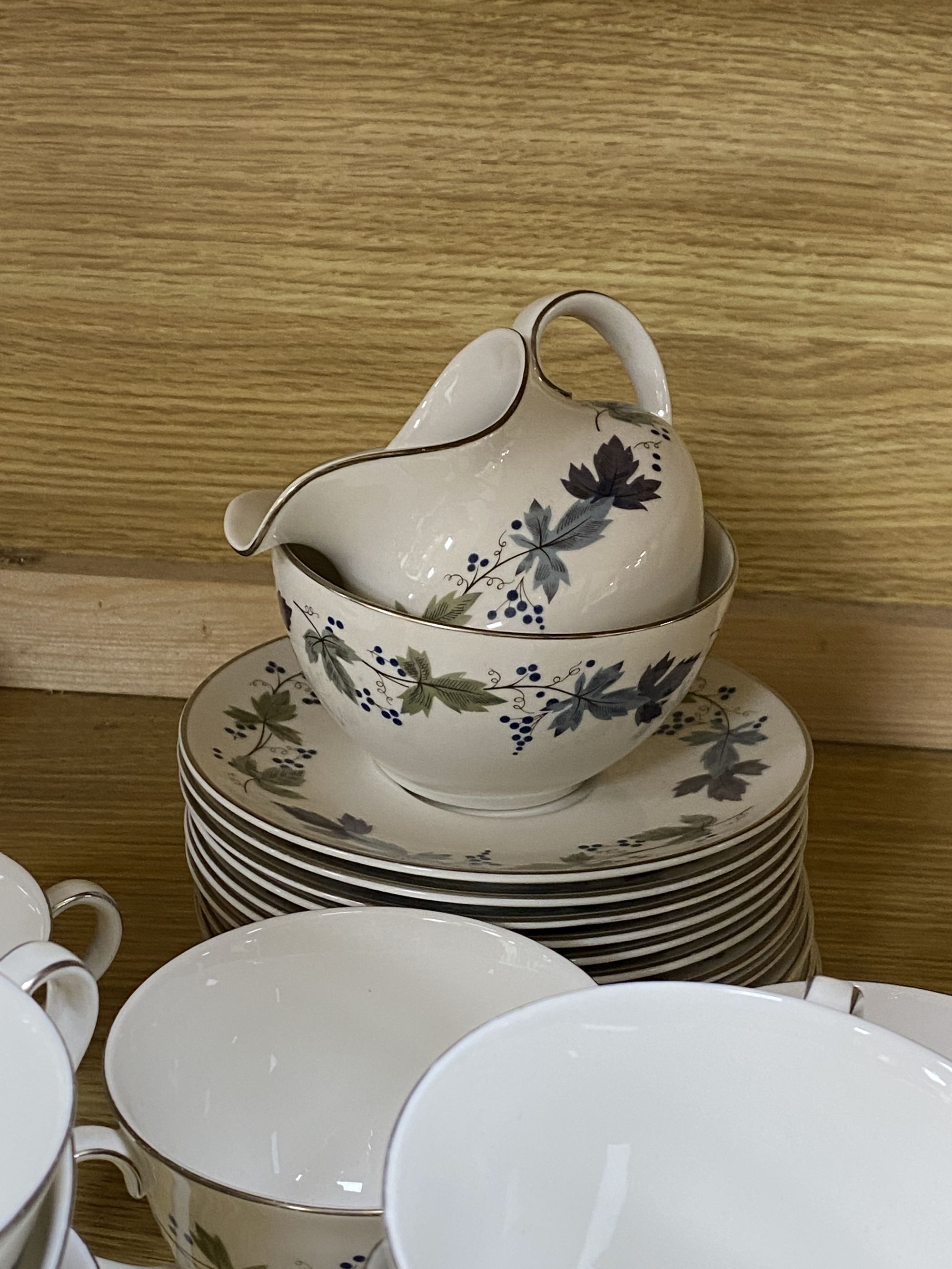 A Royal Doulton Burgundy pattern tea cups and saucers and a Doulton stoneware vase